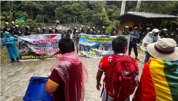 The police stand guard at the entrance of the Machu Picchu ruins during a demonstration and strike