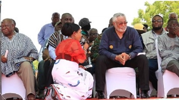 Anita Desoso (in red attire) kneels to beg former President Rawlings