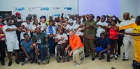 Coach Loren Seagrave in a group photo with participants and organizers afer the training
