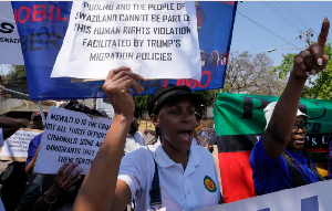 Eswatini pro-democracy activists hold placards during a protest outside the US Embassy in Pretoria