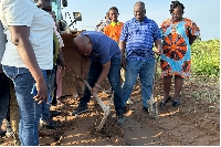Okudzeto cuts the sod for the project