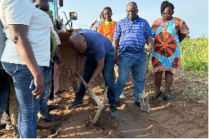 Okudzeto cuts the sod for the project