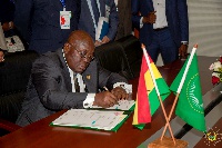 President Akufo-Addo appending his signature to the Treaties.