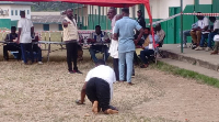 The 37-year-old physically-challenged polling station secretary makes way to cast his vote
