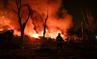 A firefighter works at the site hit by a Russian missile attack, in Zaporizhzhia