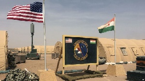 A U.S. And Niger Flag Are Raised