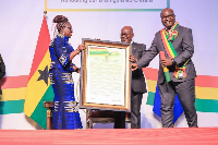 BoG Governor Dr. Ernest Addison accepting his award from President Akufo-Addo