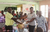 Mrs. Baisiwa Dowuona-Hammond right making the donation