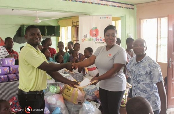 Mrs. Baisiwa Dowuona-Hammond right making the donation