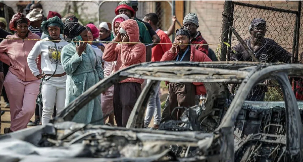 Gunmen torched vehicles as they fled the scene of a mass shooting at bar near Johannesburg