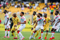 Black Stars player (in yellow jersey) marking The Gambia players during a set-piece in the game