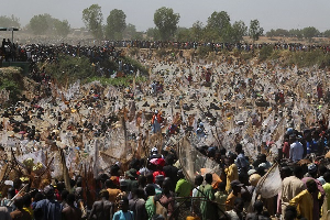 Thousands of fishermen converged on the milky waters of the Matan Fadan river