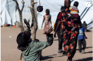 A Sudanese refugee from al-Fashir, plays with a handmade sock ball
