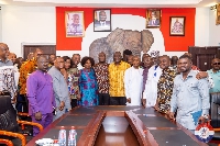 Alan (orange shirt) in a group photo with top executives at the party HQ