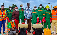 Abdulai Safian, Regional Manager of Zoomlion pose for a photo with some workers