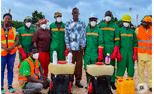 Abdulai Safian, Regional Manager of Zoomlion pose for a photo with some workers
