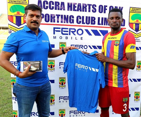 A Staff of Fero Mobile presenting an award to a player