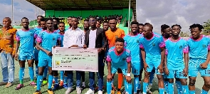 Basake Holy Stars FC receives a cheque from a benevolent group