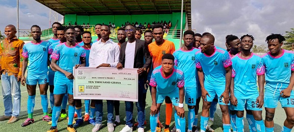 Basake Holy Stars FC receives a cheque from a benevolent group