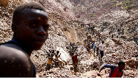 Labourers work at an open shaft of the SMB coltan mine near the town of Rubaya in DRC
