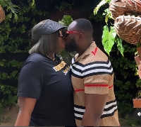Tracy and husband share a kiss