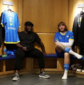 Michael Essien (left) and a friend at the Chelsea dressing room