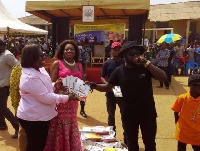 Nana Oye Lithur receives the books from Guru