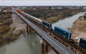 A train enters the United States over a rail bridge on the US-Mexico border in Laredo, Texas