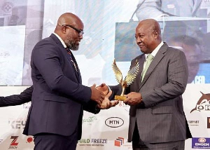 Dr Daniel McKorley receiving the award from President John Dramani Mahama