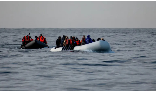 Two inflatable dinghies carrying migrants make their way across the English Channel