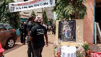 Mourners gather in the courtyard of Radio Amplitude FM during a tribute ceremony for Martinez Zogo