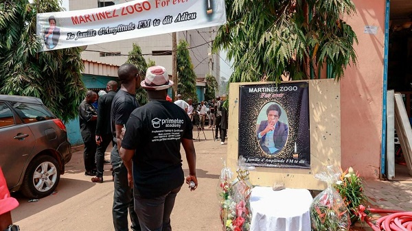 Mourners gather in the courtyard of Radio Amplitude FM during a tribute ceremony for Martinez Zogo