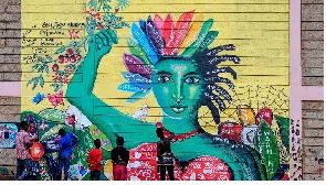 Artists paint a mural raising awareness on mental health and global climate changes in Nairobi