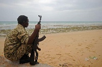 A member of the Somali security forces mans the beach on the coast of Qaw, in Puntland