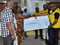 Nana Philip Archer (R) leads the GHACEM delegation to hand over the cheque to Nii Adjei Kraku II