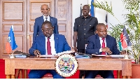 Haiti Prime Minister Ariel Henry (L) and President William Ruto witness the signing ceremony