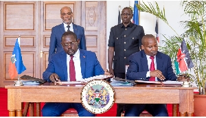 Haiti Prime Minister Ariel Henry (L) and President William Ruto witness the signing ceremony