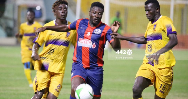 Gyan (M) during his debut for Legon Cities