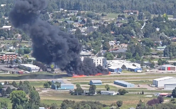 Black smoke billowing across the city after the crash