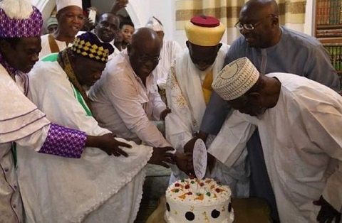 The Chief Imam being assisted to cut the birthday cake