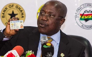 NIA Boss, Professor Ken Attafuah holding a Ghana Card