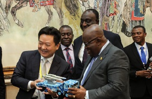 Zhang Yuzong presenting a miniature version of the types of trucks to be manufactured in Ghana
