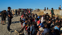 Migrants queue for food in Ceuta