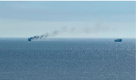 A civilian vessel appears to be on fire, as Ukraine's navy reported a Russian military strike
