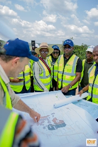 An official of Atlantic Lithium presents the plan of development to Edward Koranteng and others