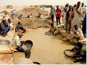 Sudanese men pan for gold