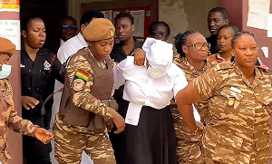 Agradaa being escorted out of the court premises by Prisons Service personnel
