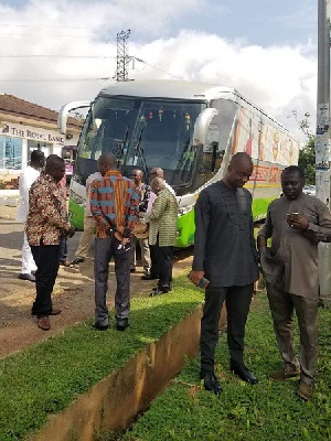 Some Ministers and MPs standing in front of an STC bus