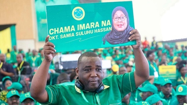 A Chama Cha Mapinduzi (CCM) delegate holds a banner at a past party congress