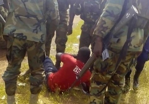 Abdul Rahaman Alhassan being guarded by Soldiers